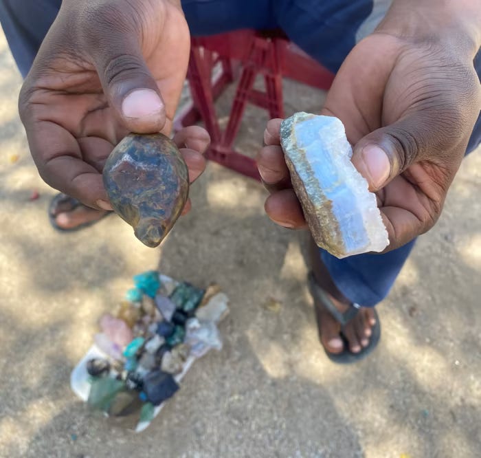 Colles Hoaeb, a local gemstone miner in Uis, displays some crystals from the area. Colles Hoaeb, a local gemstone miner in Uis, displays some crystals from the area.