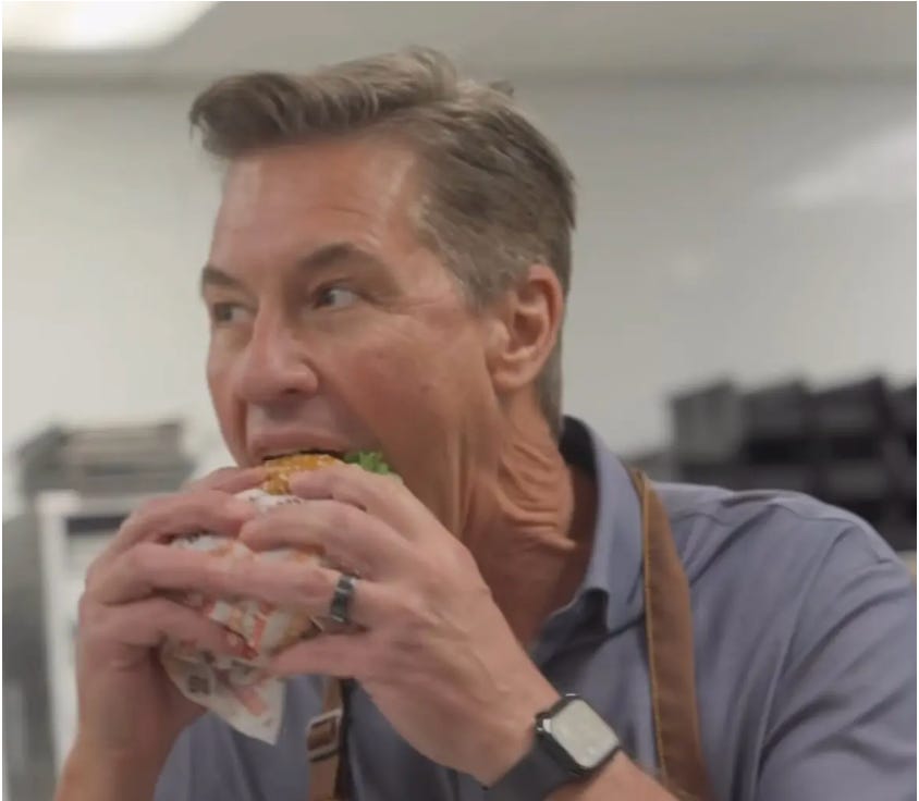 Burger King CEO looks insane taking a bite of a burger in a test kitchen Burger King CEO looks insane taking a bite of a burger in a test kitchen