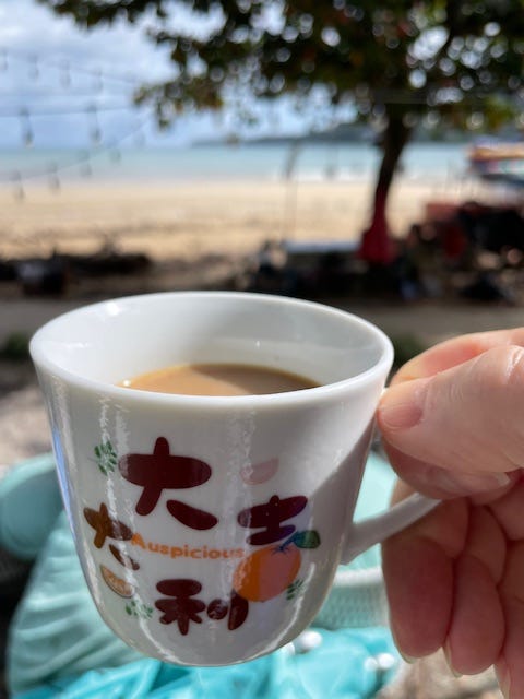 Cup of coffee beachside; oceanfront hotel room