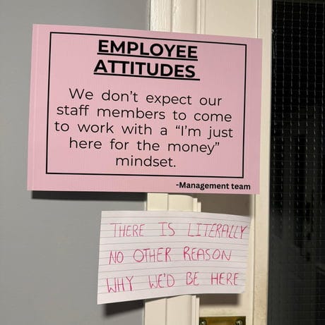 The management team's sign about employee attitudes is humorously contradicted by a handwritten note below it, stating the obvious truth about why people work.
