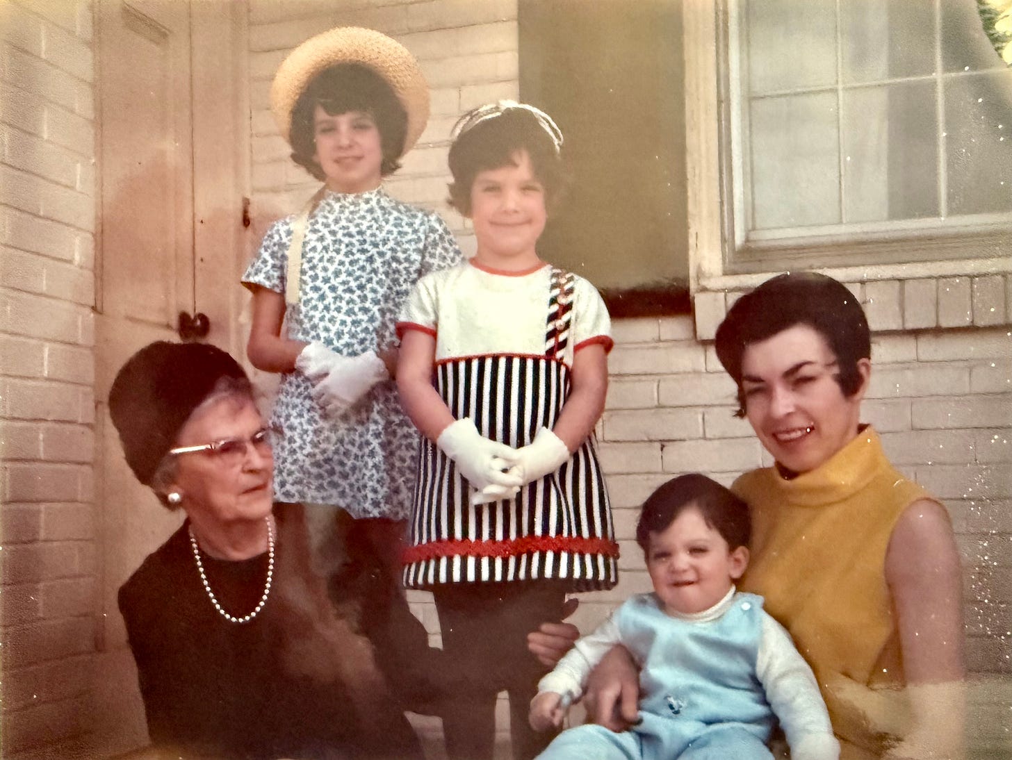 Gram Post with Mom holding my brother John. Chris (top right) and me in our Easter clothes.