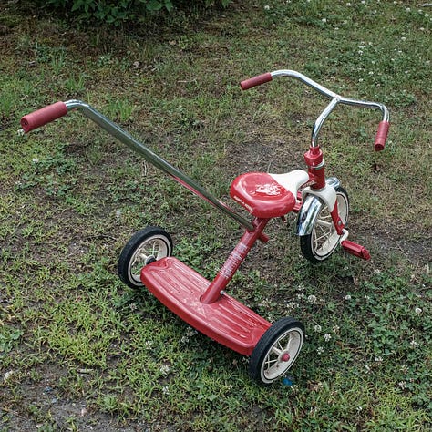 A 2 x 3 grid of six photographs with red things: a round red circle above a hard beam, an upside down red plastic chair, leaves from a red Japanese maple, a red watering, a red Radio Flyer tricycle and a bowl of red rotting watermelon 