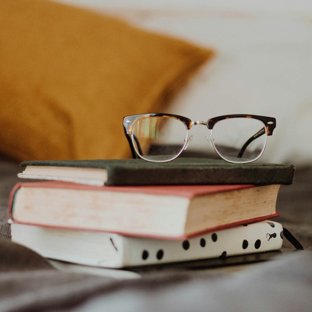club master eyeglasses on pile of three books club master eyeglasses on pile of three books