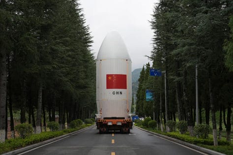 The Long March 2D 100th first-stage, second-stage, and fairing heading to and being placed onto Launch Complex 3.