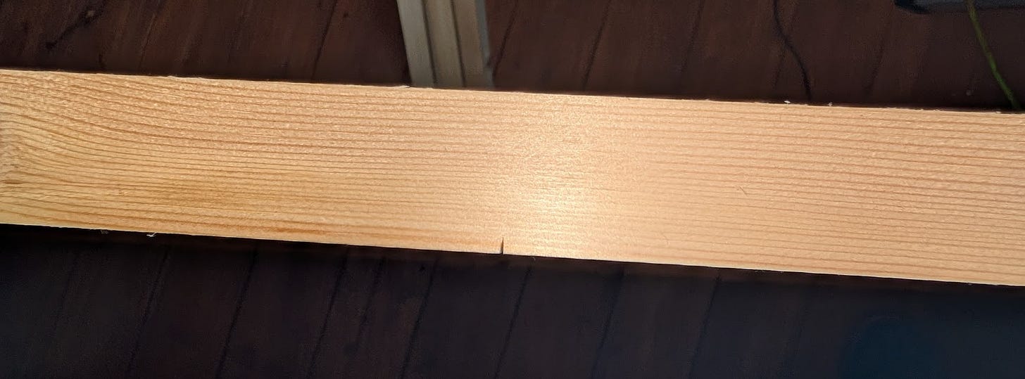 long piece of wood with tiny score mark