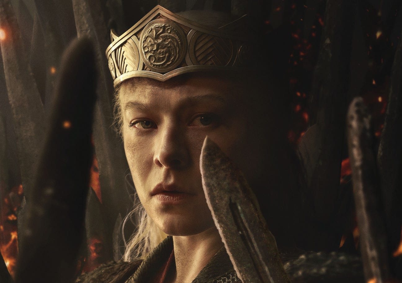 Rhaenyra wears her crown and holds up a sword.
