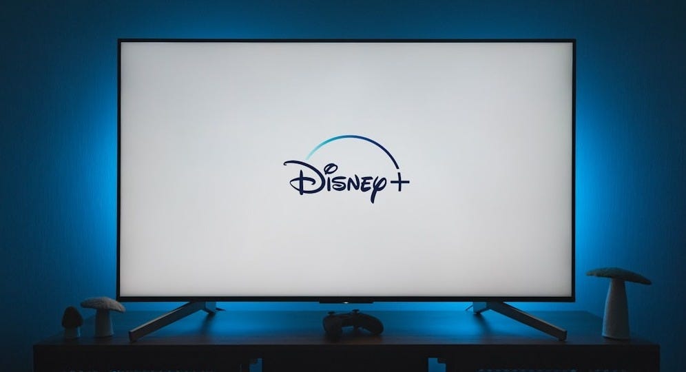 a flat screen tv sitting on top of a wooden table