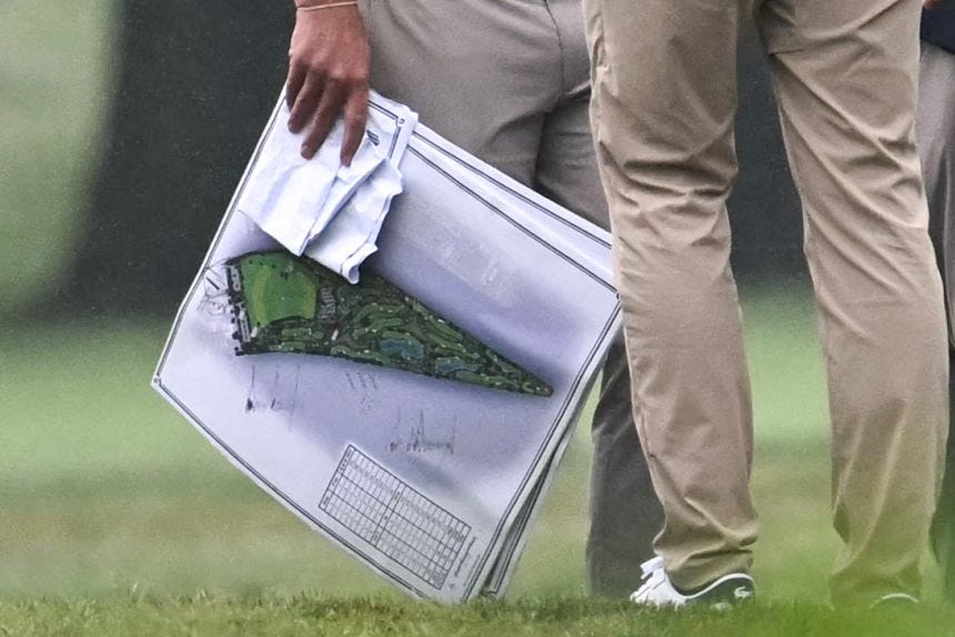 A person holds architectural plans signed by President Donald Trump, as Trump makes a visit to East Potomac Golf Links in Washington, DC, on June 28, 2026.
