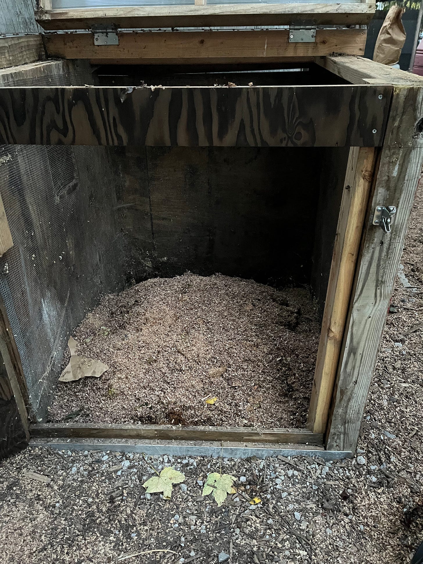 A compost pile in one of the bins of a 3-bin compost system