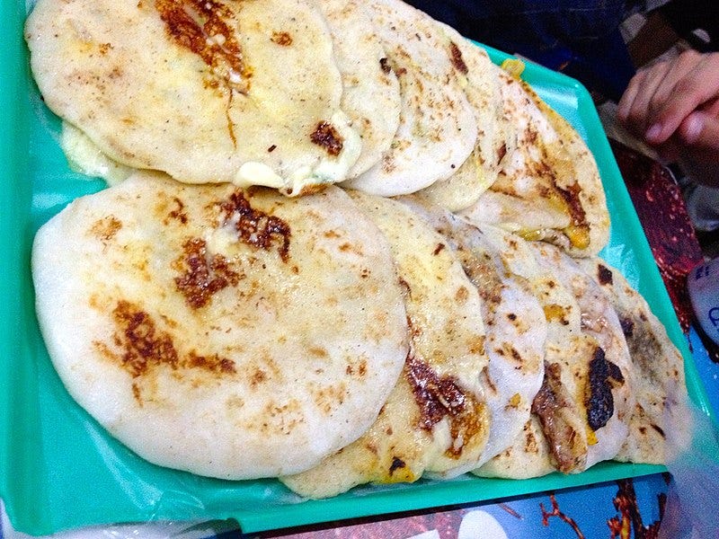File:Pupusas in San Salvador - 8449776576.jpg