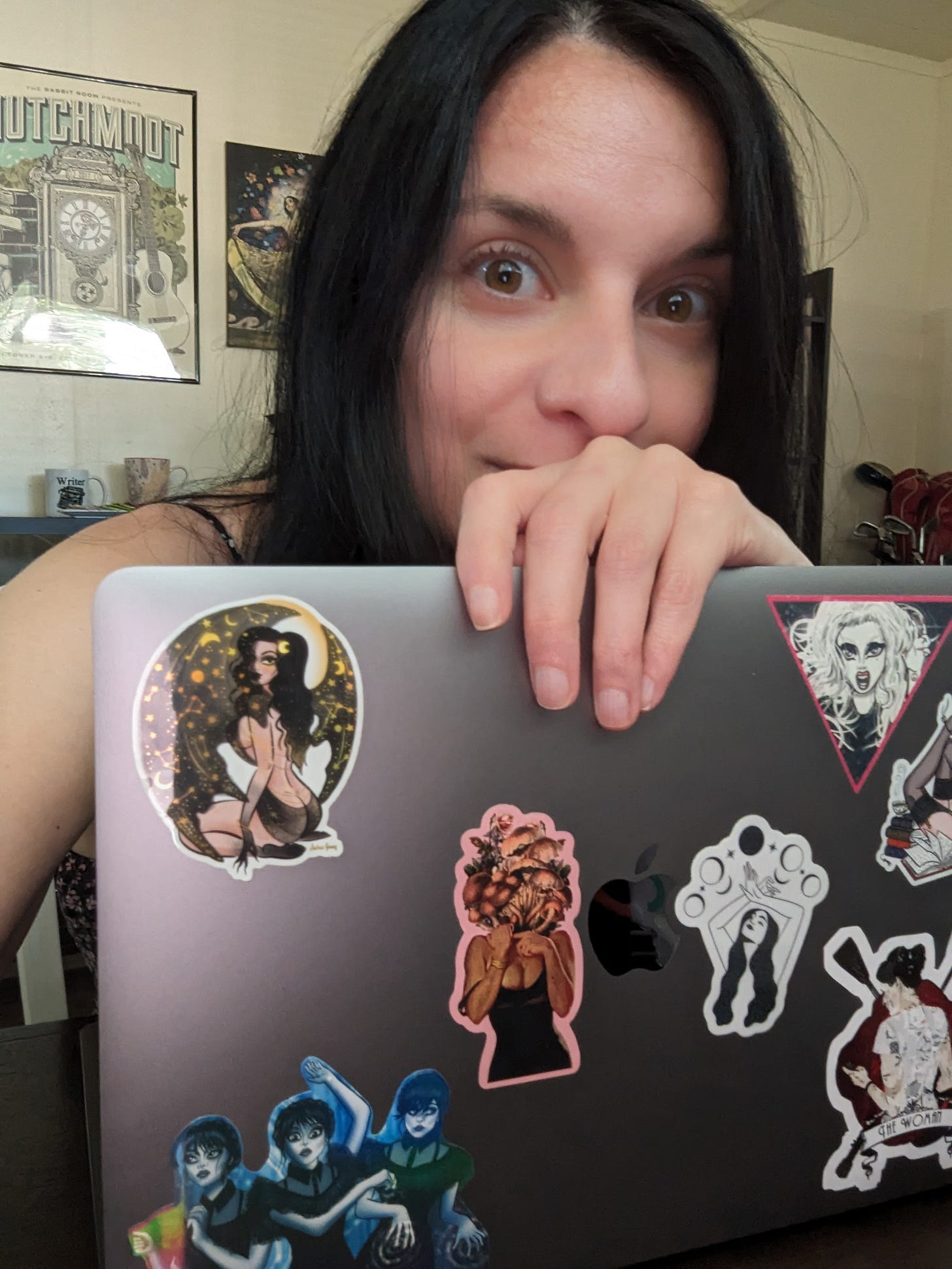 Desiree coyly smiles behind her laptop as she wonders how she will describe her muses. Desiree coyly smiles behind her laptop as she wonders how she will describe her muses.
