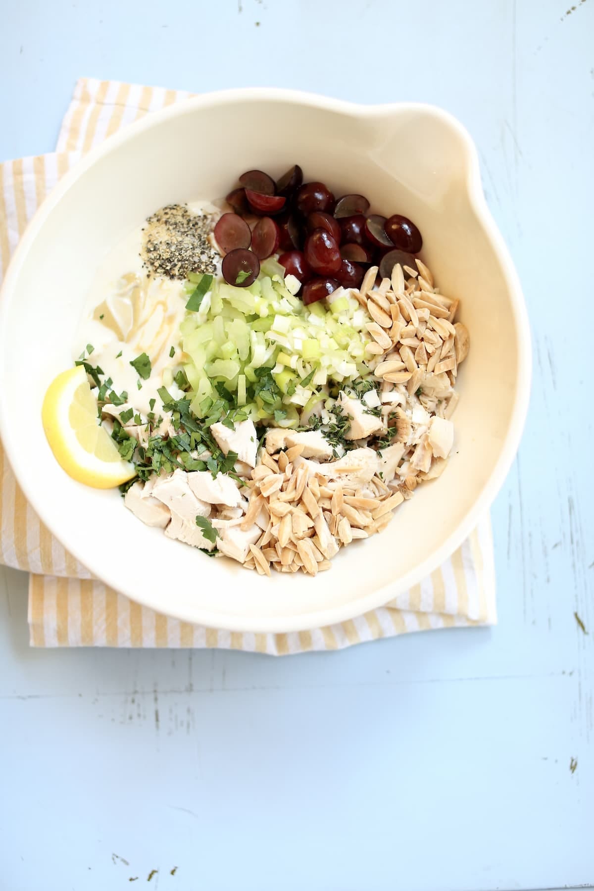 a bowl with ingredients for rotisserie chicken salad