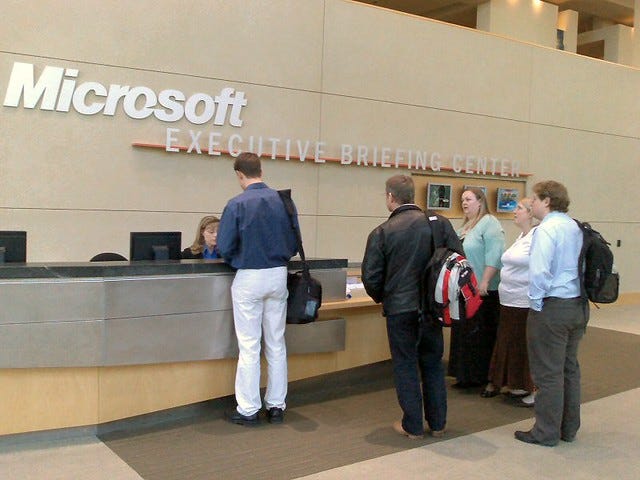 Photo of people being welcomed at the Microsoft Executive Briefing center Photo of people being welcomed at the Microsoft Executive Briefing center