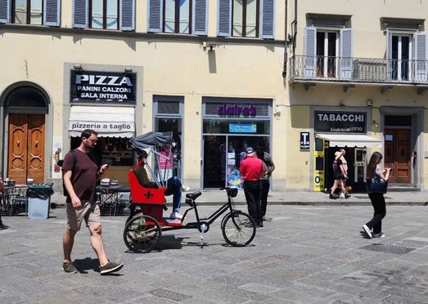 A person walking on a street with a bicycle and a bicycle

AI-generated content may be incorrect.