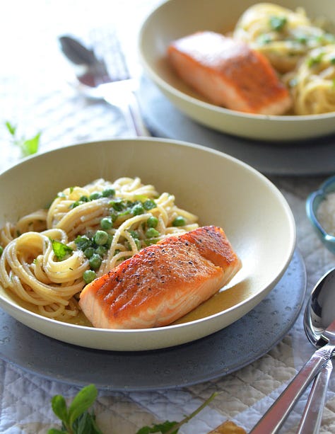 photos of fish almandine on a platter, seafood risotto in a white bowl, Karista pouring a seafood boil onto a plastic tablecloth, Karista holding a whole roasted fish, salmon with brown butter pasta with peas and mint and a crispy fish burger with special sauce sitting on a wooden board