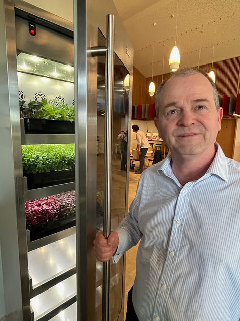 Three photos, first is leaves of Mexican Marigold leaves on a white plate; second photo, closeup of a tray of microleaves, and thirdly an image of Jason Hirst opening the growing machine that the company makes.