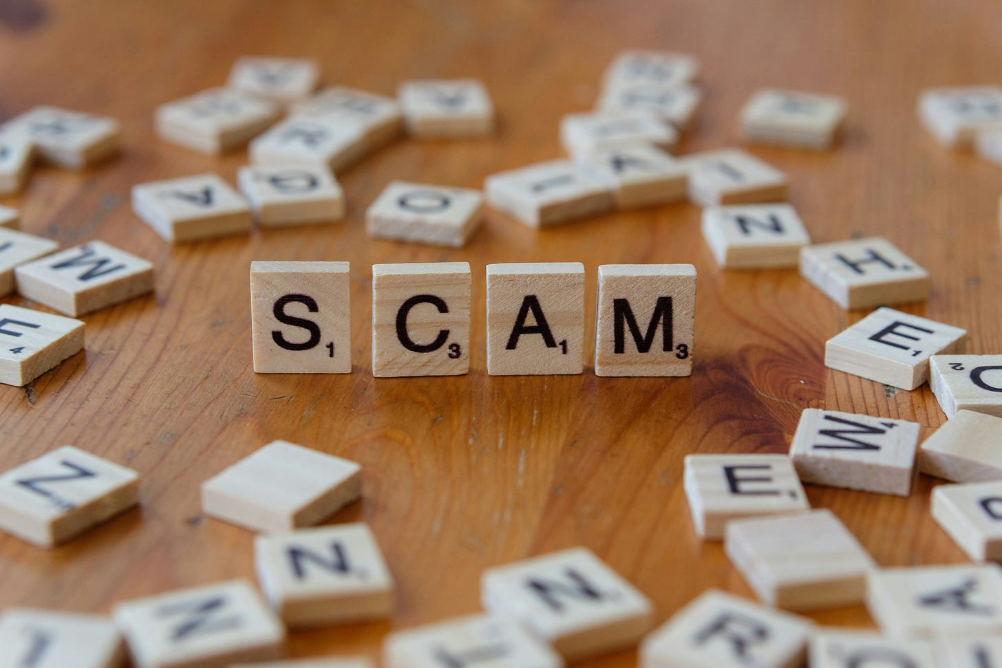 SCAM spelled out with Scrabble letters SCAM spelled out with Scrabble letters