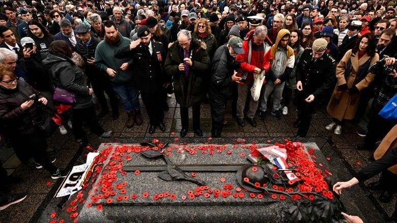 People place poppies on the Tomb of the Unknown Soldier after the Remembrance Day ceremony at the National War Memorial in Ottawa, on Monday, Nov. 11, 2024. People place poppies on the Tomb of the Unknown Soldier after the Remembrance Day ceremony at the National War Memorial in Ottawa, on Monday, Nov. 11, 2024.