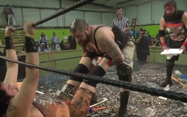 [Screenshot: Chuey attacks Mosh Pit Mike in the ropes]