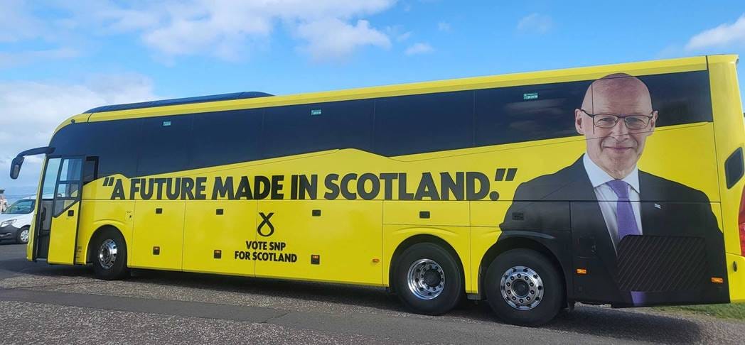 A yellow bus with a picture of a person on it

AI-generated content may be incorrect.