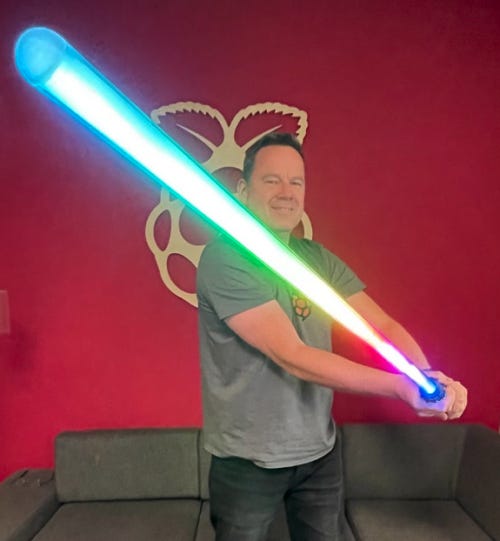toby roberts with a multi coloured light saber he made