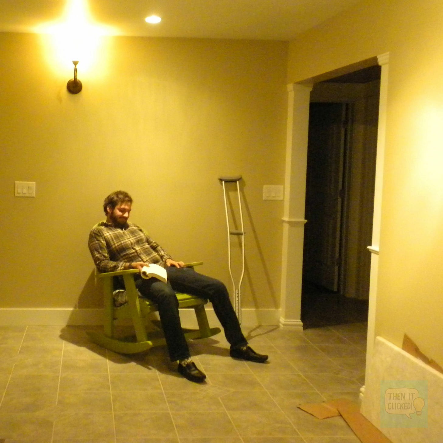 my bearded brother reading in a rocking chair indoors amongst an empty yellow room my bearded brother reading in a rocking chair indoors amongst an empty yellow room