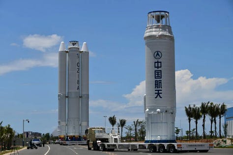 The vehicle's boosters being prepared for flight (left), the first and second stages heading to the launch pad (center), and teams preparing to lift the rocket's fairing (right).