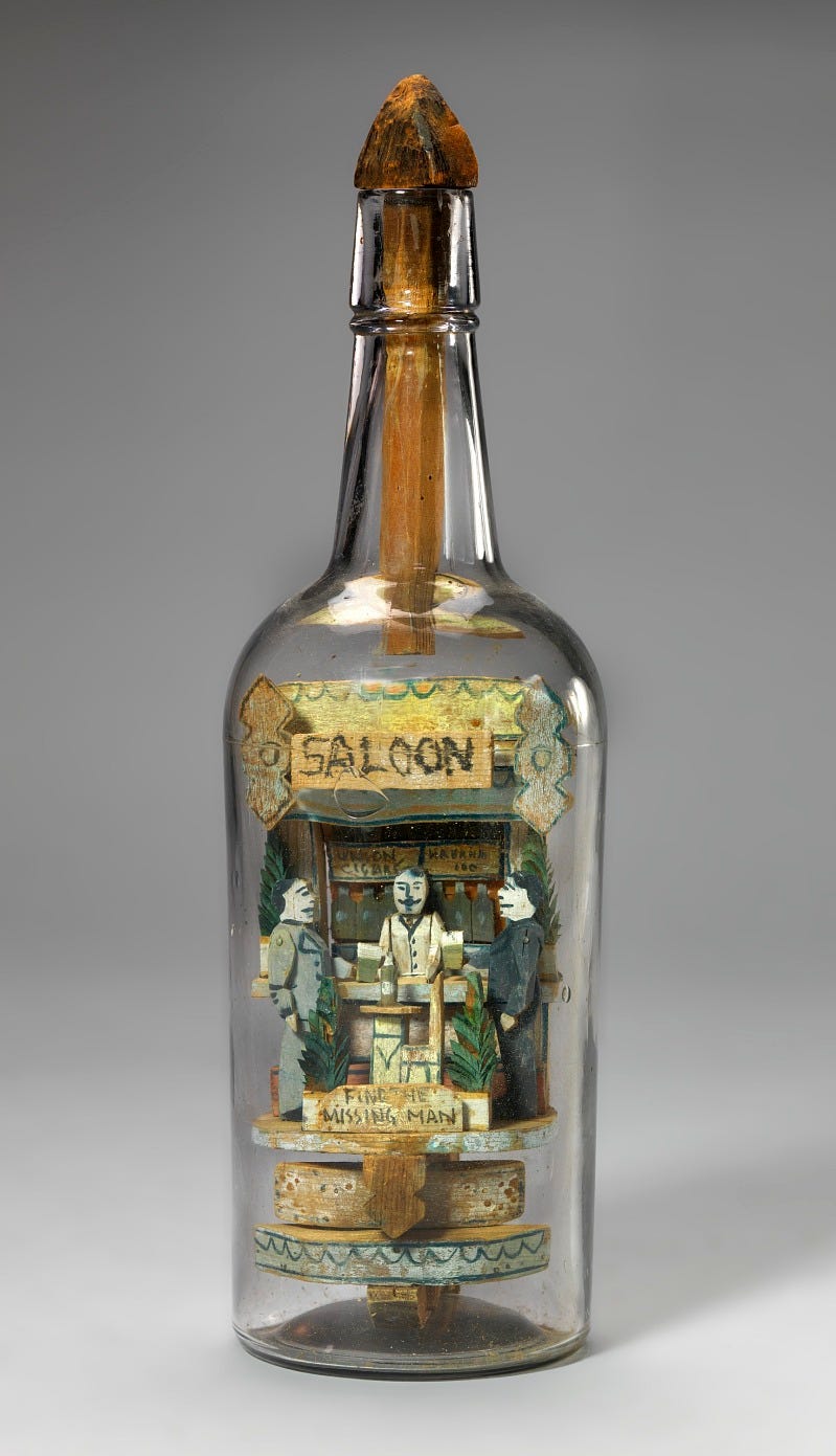 a photo of a glass bottle with a 3d sculpture of two men sitting at a bar with a bartender behind it and the word 'saloon' across the top a photo of a glass bottle with a 3d sculpture of two men sitting at a bar with a bartender behind it and the word 'saloon' across the top