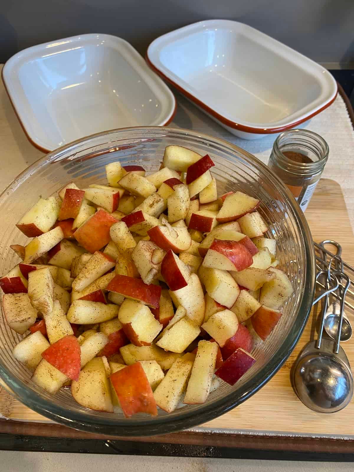 Dish of chopped red apples coated in cinnamon.