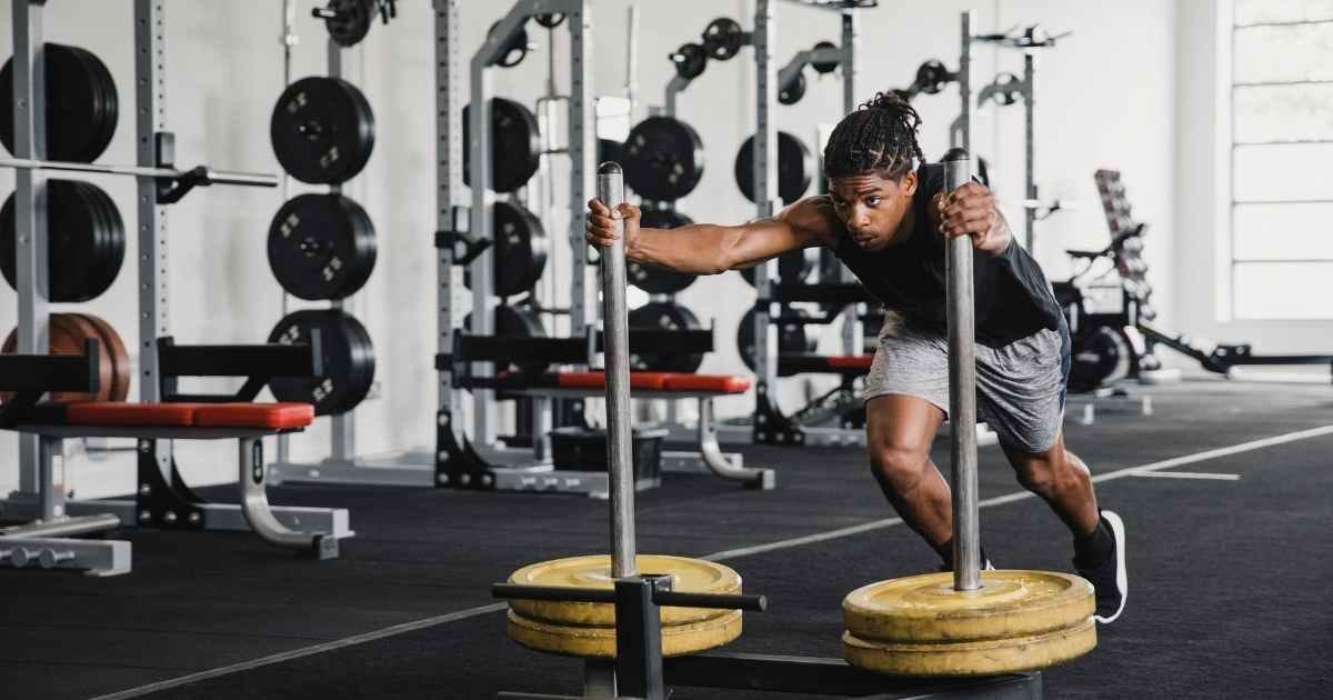Young man pushing the sled Young man pushing the sled