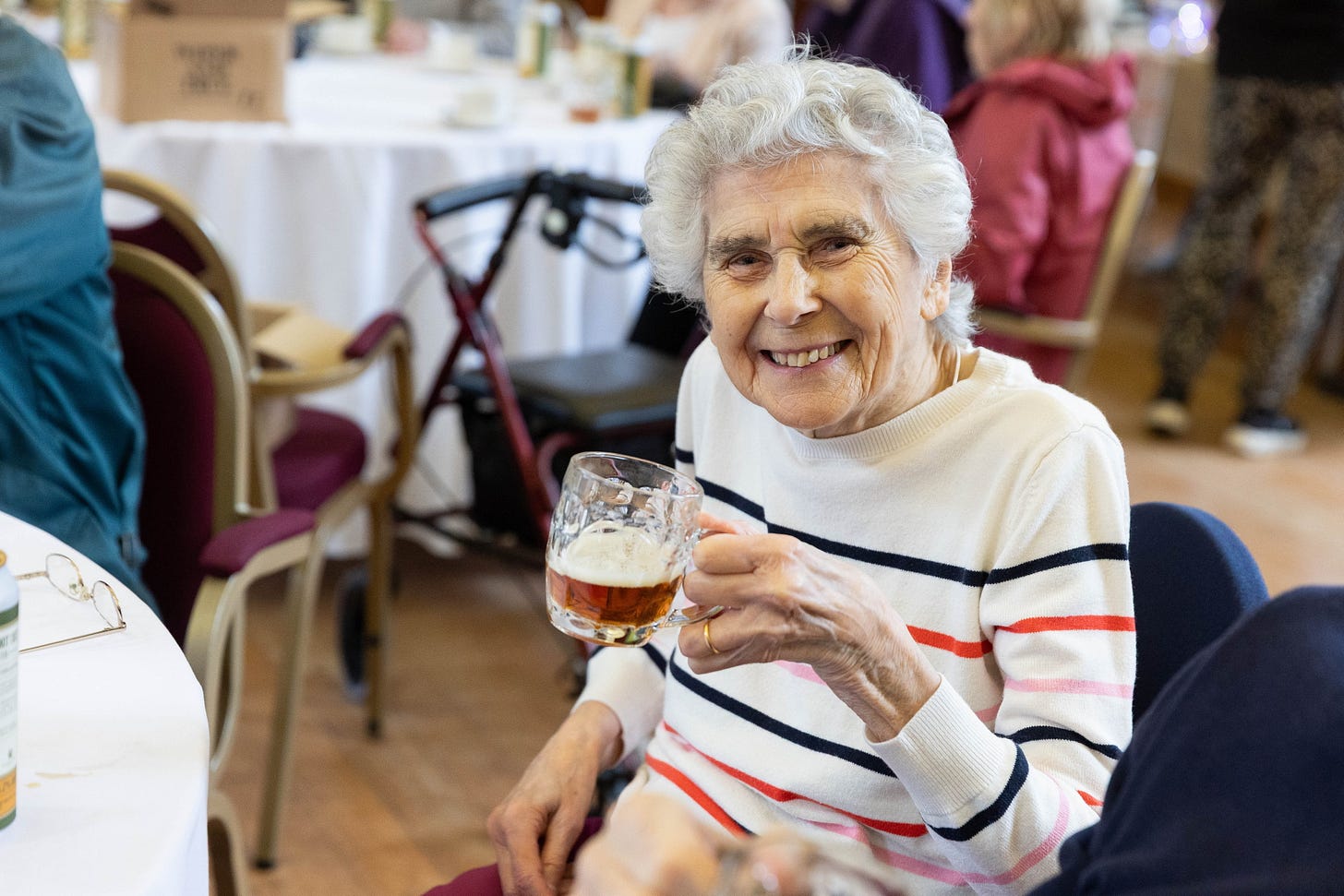 Care home resident enjoys a beer made from hops grown in their garden