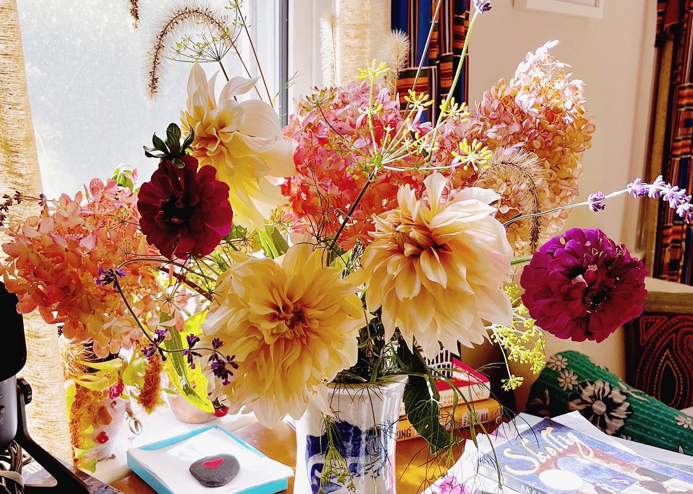 bouquet of apricot-colored dahlias, pink hydrangeas and purple zinnias