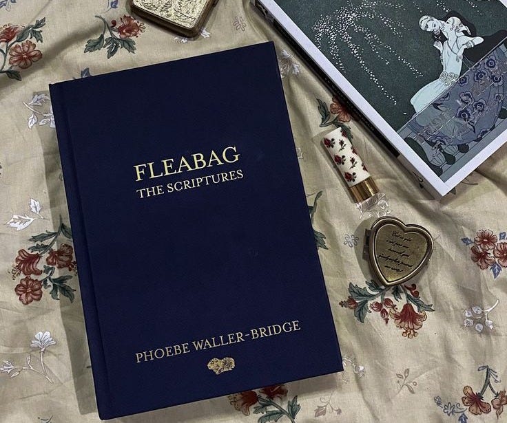 This may contain: there is a book and some other items on the bed with it's cover