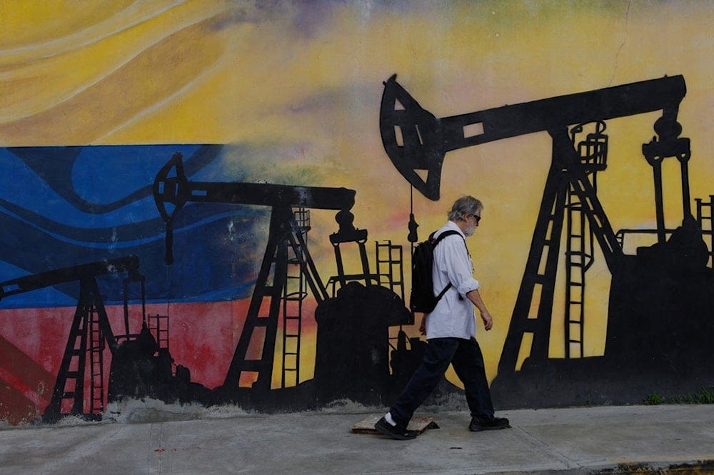 A pedestrian walks past a mural featuring oil wells in Caracas, Venezuela, Saturday, Aug 29, 2026, a day after President Donald Trump announced a deal giving the United States a stake in Venezuela’s oil reserves. (AP Photo/Pedro Mattey) A pedestrian walks past a mural featuring oil wells in Caracas, Venezuela, Saturday, Aug 29, 2026, a day after President Donald Trump announced a deal giving the United States a stake in Venezuela’s oil reserves. (AP Photo/Pedro Mattey)