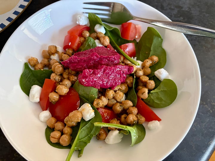 A packet of goats cheese and a salad 