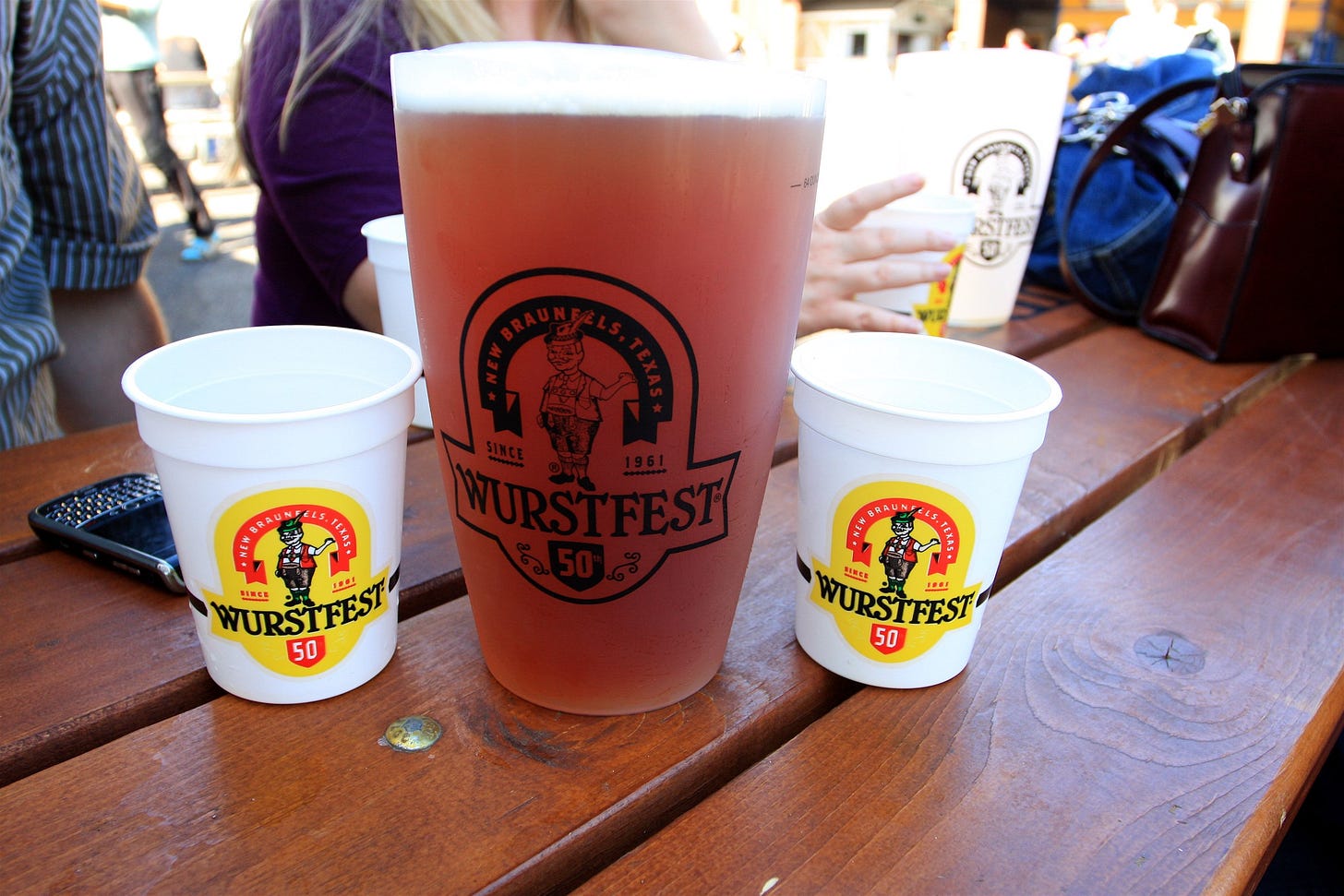 Beer in Wurstfest cups on a picnic table in New Braunfels, Texas