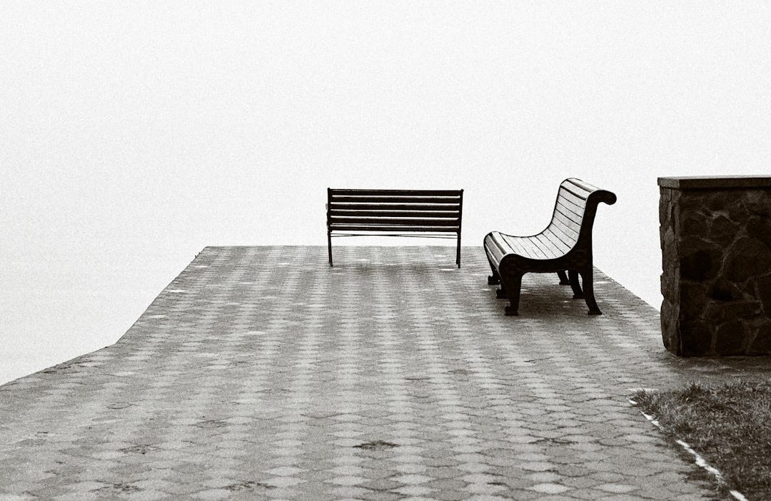 black metal bench on gray concrete floor