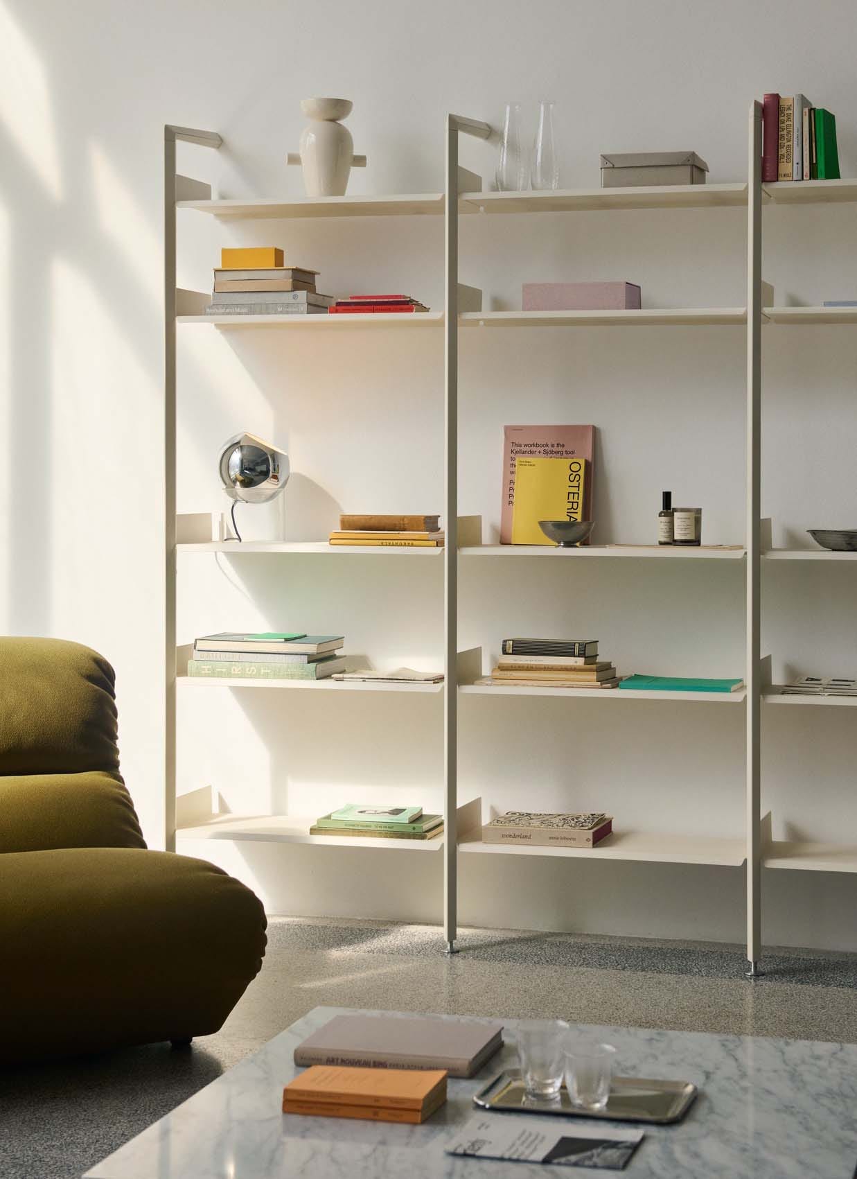 White modular shelving system decorated with books and trinkets