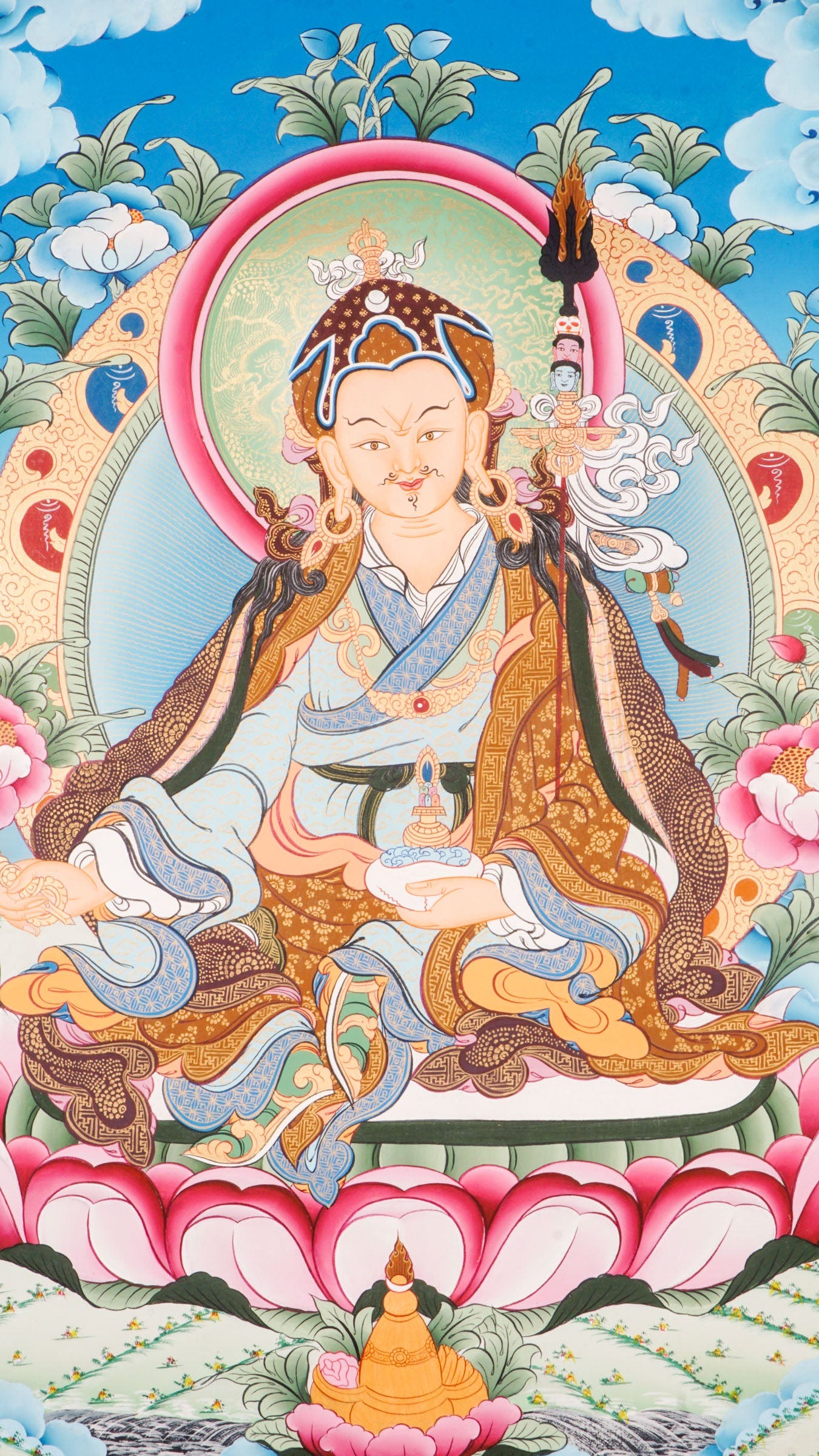 Thangka painting showing a seated robed figure on a pink lotus pedestal, holding an object in both hands, framed by a circular halo, clouds, flowers, and a stylized landscape.
