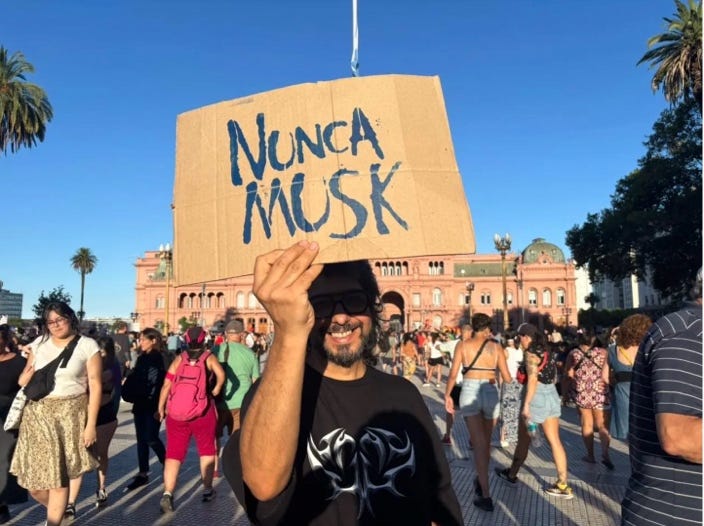 A person holding a cardboard sign

Description automatically generated