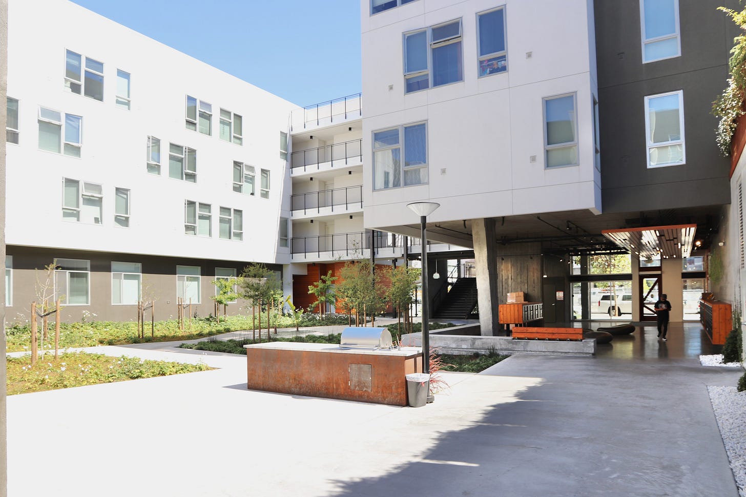 The courtyard of the Five88 affordable housing is shown with landscaped areas and places to sit.