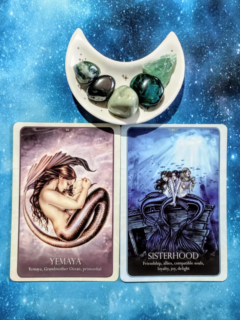 Can You Feel the Love? A Message From the Universe, 2 Oracle of the Mermaids cards and crystals on a starry blue background