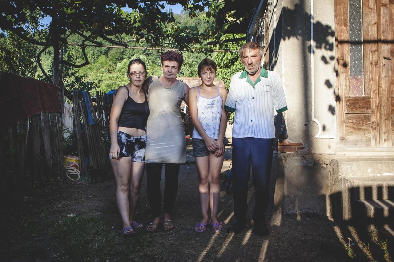 Szuhányi with his family outside their home in Transylvania.