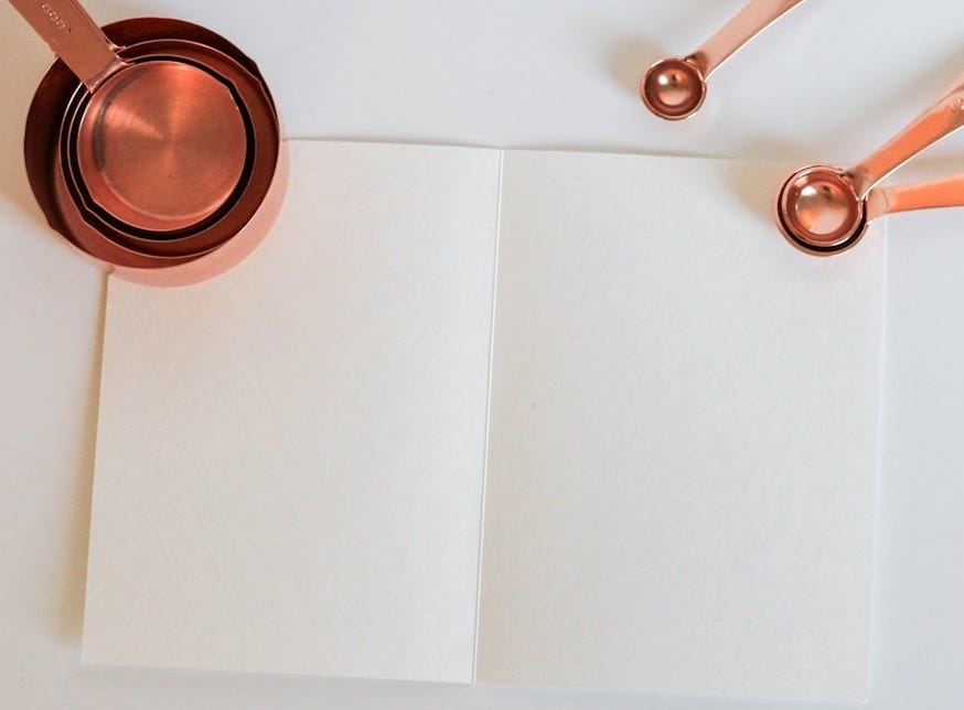 measuring cup on white paper