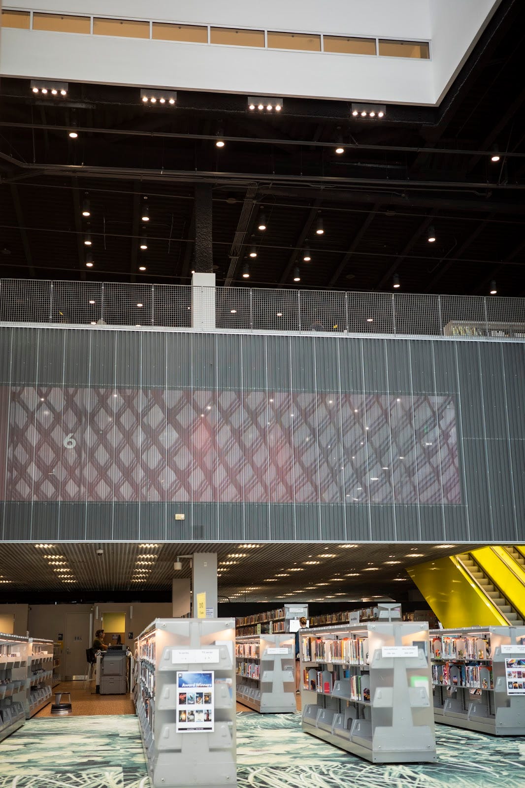 The interior of the Seattle Public Library Central branch, with large open space above the stacks.
