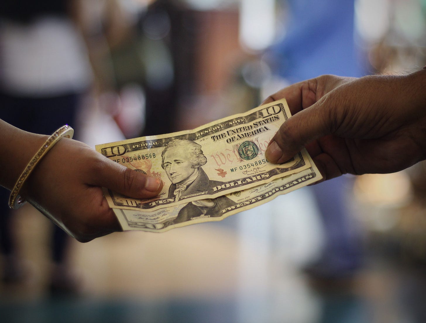 Two partners exchange money.