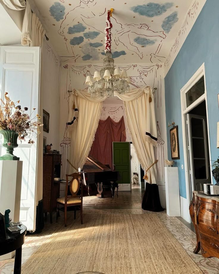 This may contain: a room with blue walls and white drapes on the ceiling is decorated with clouds
