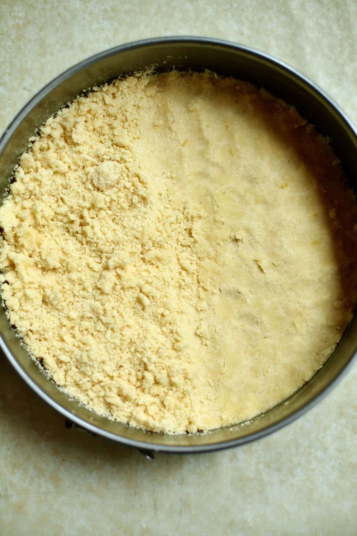 a baking pan with raw cookie dough, pressed on one side, loose on the other to show the difference between the two