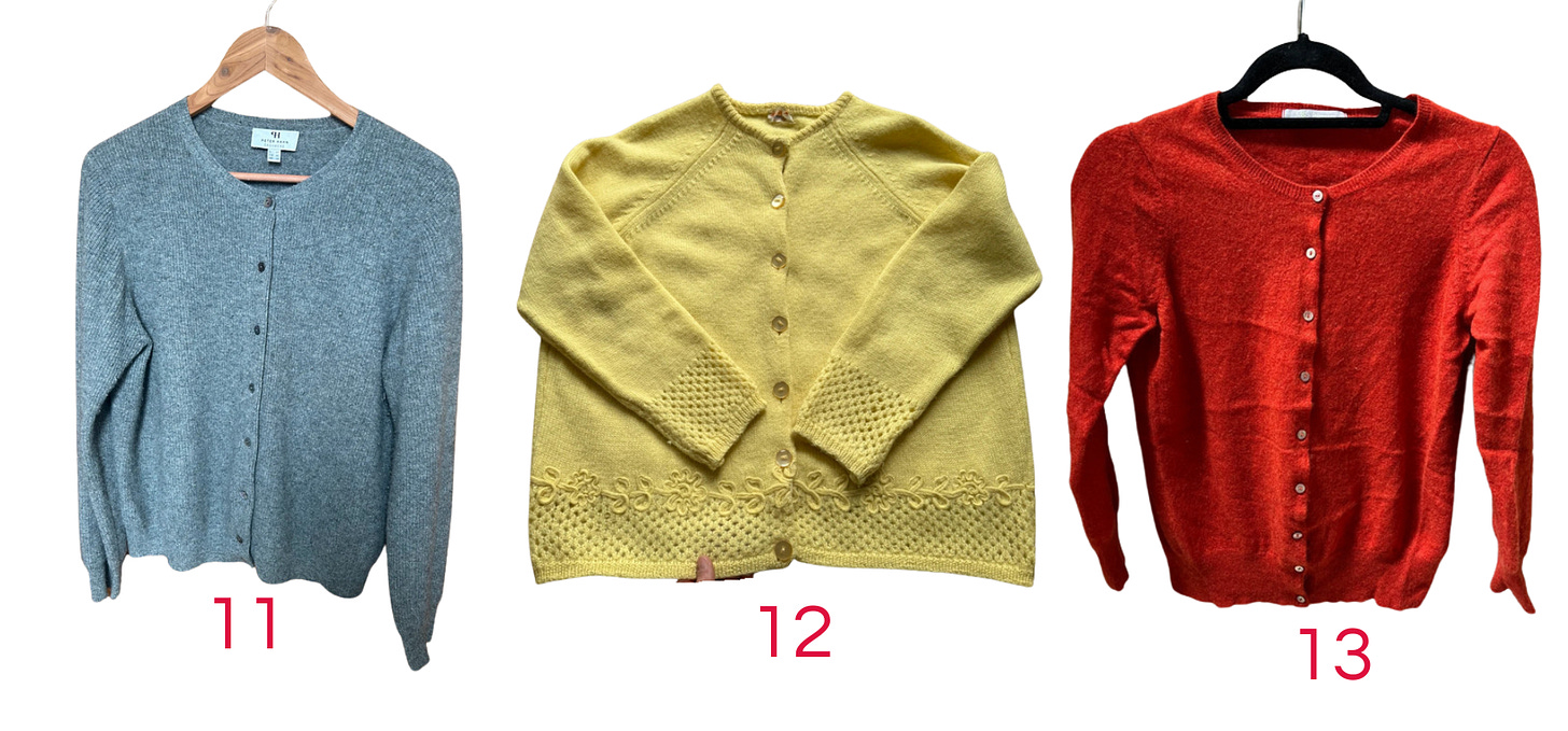 A grey cardigan, a yellow cardigan, and a red cardigan
