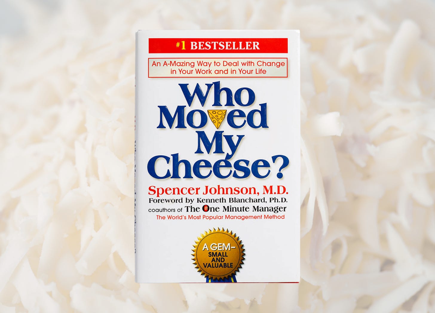 Cover of the book Who Moved My Cheese? by Spencer Johnson, featuring the title text and a small cheese icon, symbolizing change, adaptation, and leadership lessons.